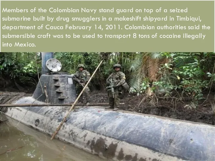 Members of the Colombian Navy stand guard on top of a