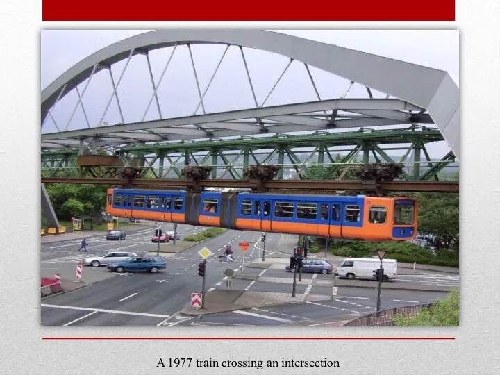 A 1977 train crossing an intersection