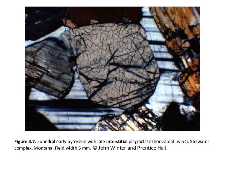 Figure 3.7. Euhedral early pyroxene with late interstitial plagioclase (horizontal twins).