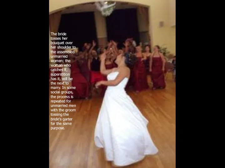 The bride tosses her bouquet over her shoulder to the assembled