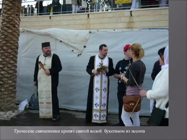 Греческие священники кропят святой водой букетиком из иссопа