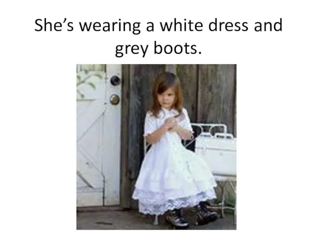 She’s wearing a white dress and grey boots.