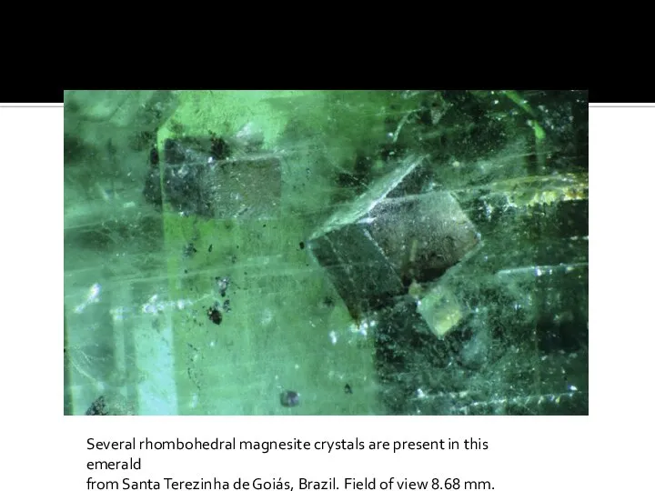 Several rhombohedral magnesite crystals are present in this emerald from Santa