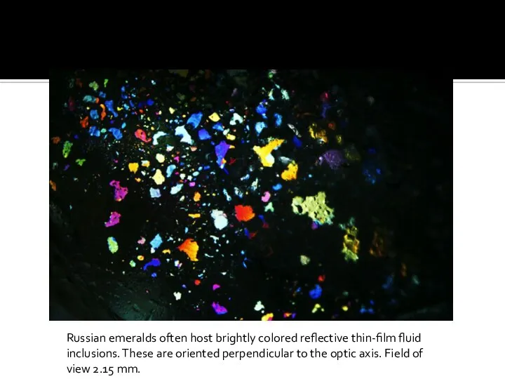 Russian emeralds often host brightly colored reflective thin-film fluid inclusions. These