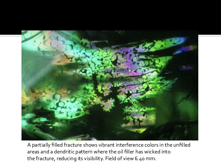 A partially filled fracture shows vibrant interference colors in the unfilled