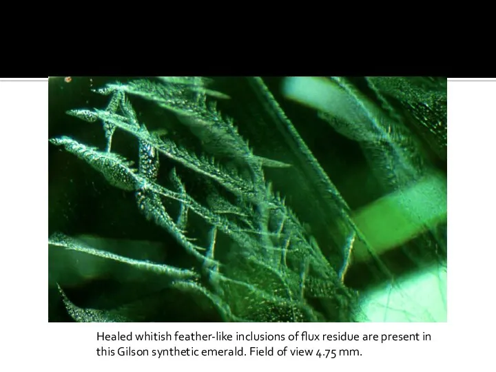 Healed whitish feather-like inclusions of flux residue are present in this