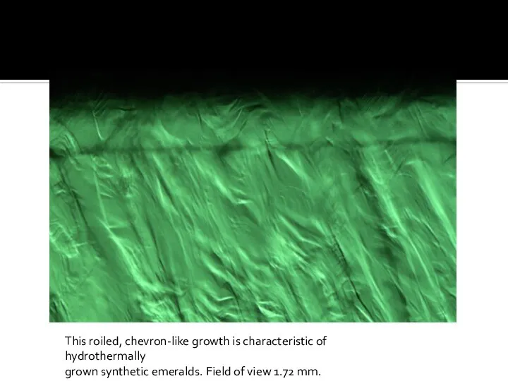 This roiled, chevron-like growth is characteristic of hydrothermally grown synthetic emeralds. Field of view 1.72 mm.